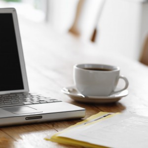 Laptop on Kitchen Table with Cup of Coffee